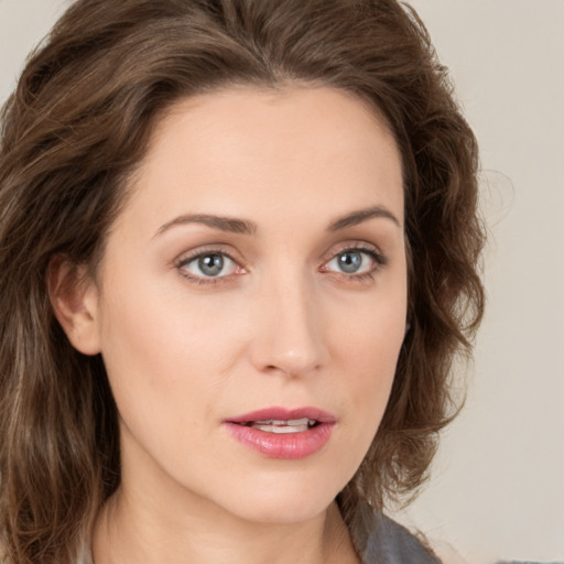 Joyful white young-adult female with long  brown hair and green eyes