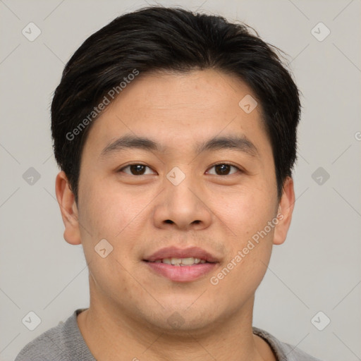 Joyful asian young-adult male with short  brown hair and brown eyes