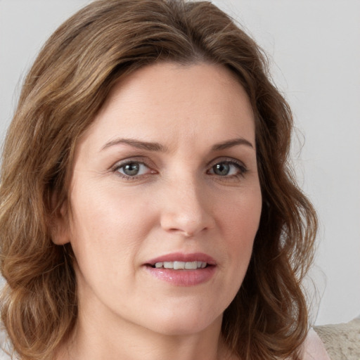 Joyful white young-adult female with medium  brown hair and blue eyes