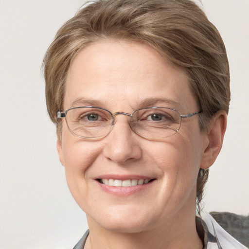 Joyful white adult female with medium  brown hair and grey eyes