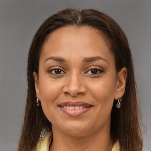 Joyful latino young-adult female with long  brown hair and brown eyes