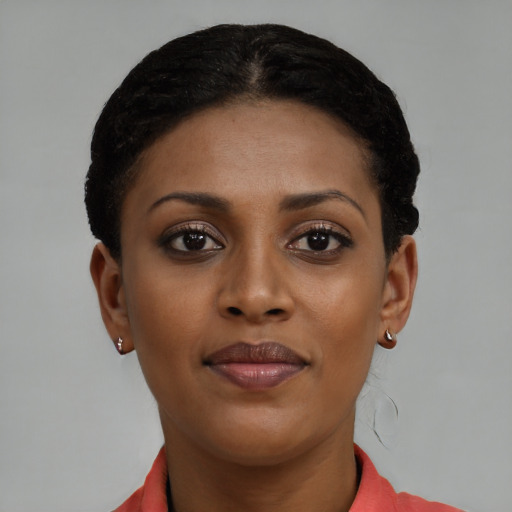 Joyful black young-adult female with short  brown hair and brown eyes