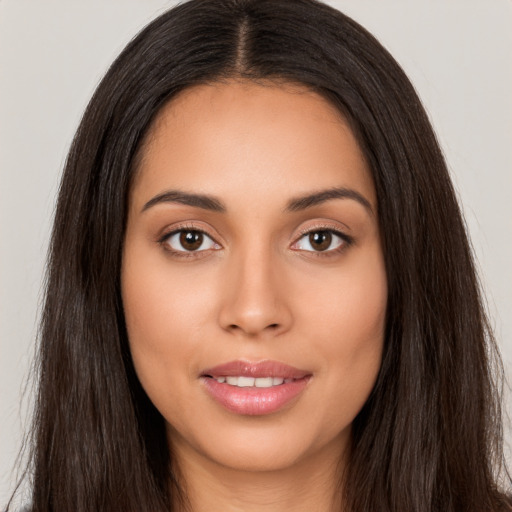 Joyful latino young-adult female with long  brown hair and brown eyes