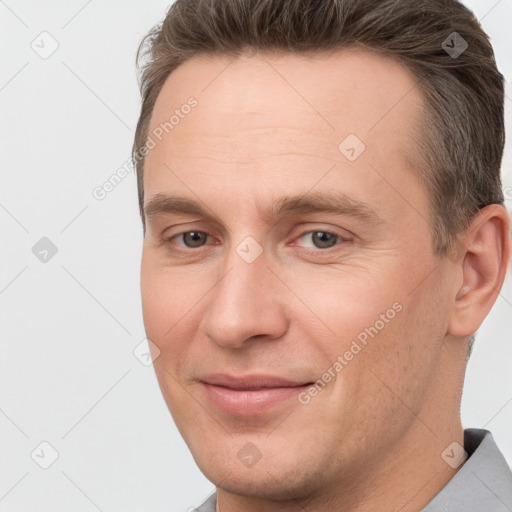 Joyful white adult male with short  brown hair and brown eyes