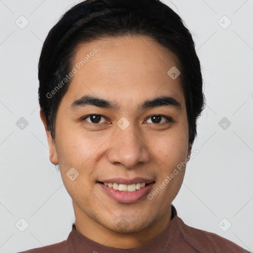 Joyful latino young-adult male with short  black hair and brown eyes