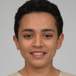 Joyful latino young-adult male with short  brown hair and brown eyes