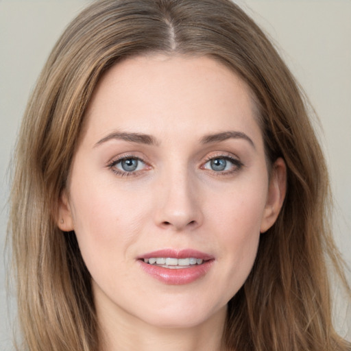 Joyful white young-adult female with long  brown hair and grey eyes