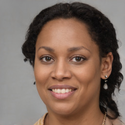 Joyful black young-adult female with medium  brown hair and brown eyes