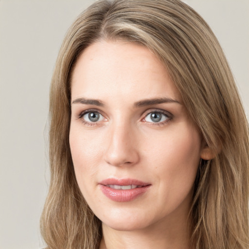 Joyful white young-adult female with long  brown hair and grey eyes