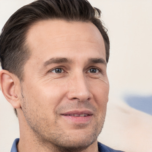 Joyful white adult male with short  brown hair and brown eyes