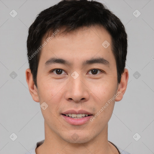 Joyful asian young-adult male with short  brown hair and brown eyes