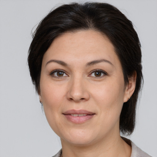 Joyful white adult female with medium  brown hair and brown eyes