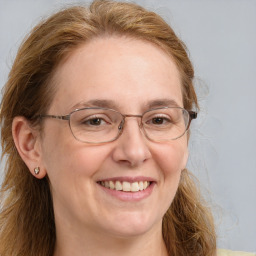 Joyful white adult female with long  brown hair and brown eyes