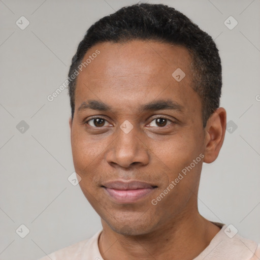 Joyful black young-adult male with short  black hair and brown eyes