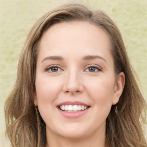 Joyful white young-adult female with long  brown hair and green eyes