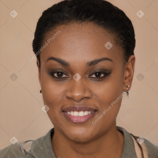 Joyful black young-adult female with short  black hair and brown eyes