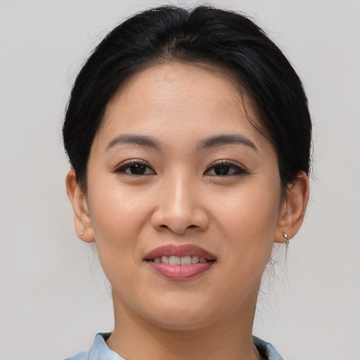 Joyful asian young-adult female with short  brown hair and brown eyes