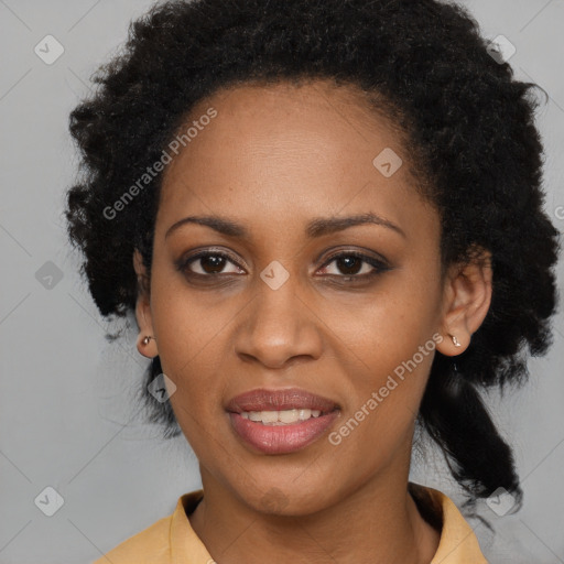 Joyful black young-adult female with short  black hair and brown eyes