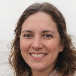 Joyful white adult female with long  brown hair and brown eyes