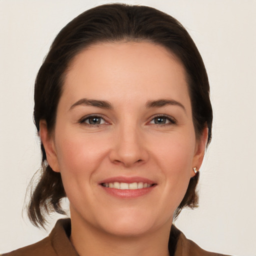 Joyful white young-adult female with medium  brown hair and brown eyes