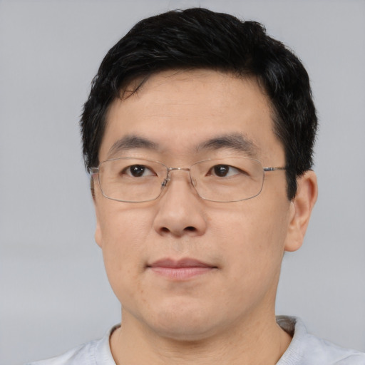 Joyful asian adult male with short  black hair and brown eyes