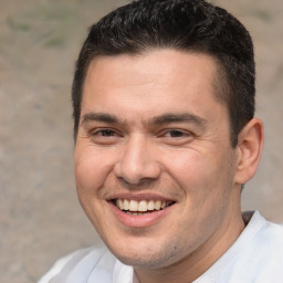 Joyful white adult male with short  brown hair and brown eyes