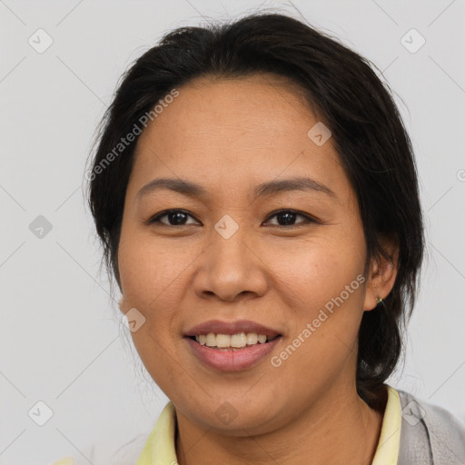 Joyful asian adult female with medium  brown hair and brown eyes