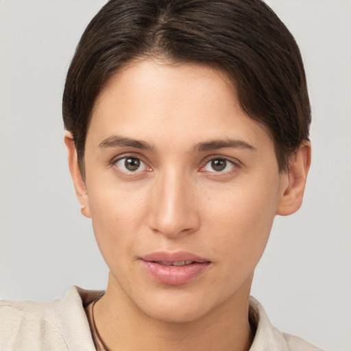 Joyful white young-adult female with short  brown hair and brown eyes