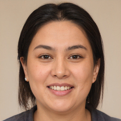 Joyful white young-adult female with medium  brown hair and brown eyes