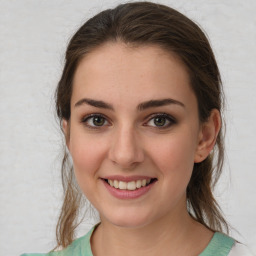 Joyful white young-adult female with medium  brown hair and green eyes