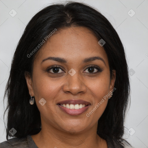 Joyful black young-adult female with long  brown hair and brown eyes