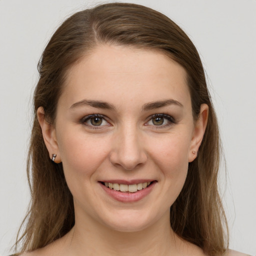 Joyful white young-adult female with long  brown hair and grey eyes