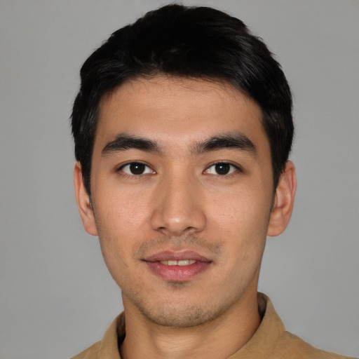 Joyful asian young-adult male with short  black hair and brown eyes
