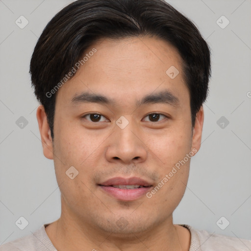 Joyful asian young-adult male with short  brown hair and brown eyes