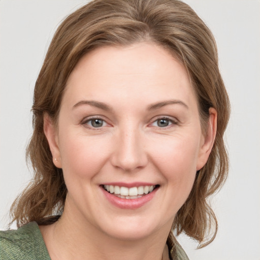 Joyful white young-adult female with medium  brown hair and green eyes