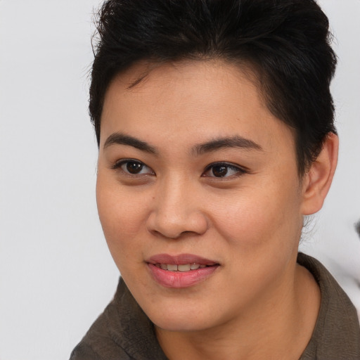 Joyful asian young-adult female with short  brown hair and brown eyes