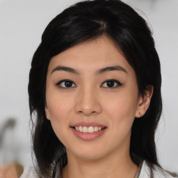 Joyful asian young-adult female with medium  black hair and brown eyes