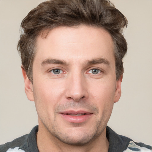 Joyful white adult male with short  brown hair and grey eyes