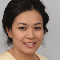 Joyful white young-adult female with medium  brown hair and brown eyes