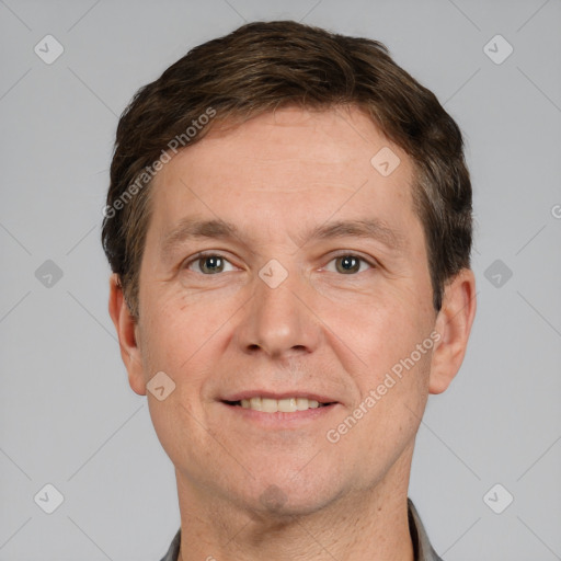 Joyful white adult male with short  brown hair and grey eyes