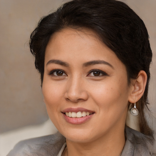 Joyful latino young-adult female with medium  brown hair and brown eyes