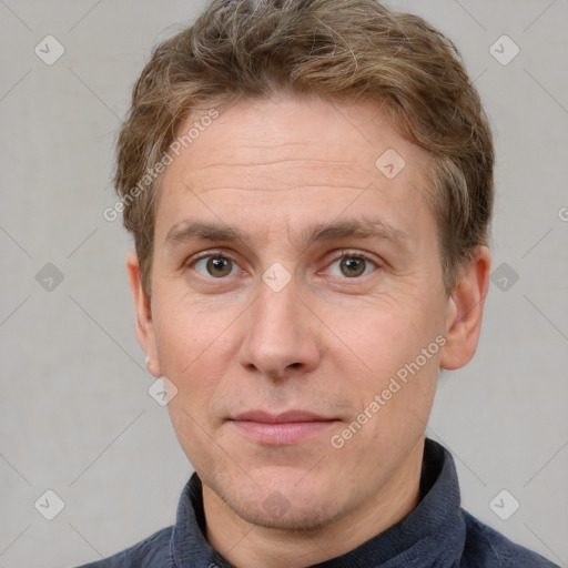 Joyful white adult male with short  brown hair and grey eyes