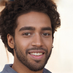 Joyful black young-adult male with short  brown hair and brown eyes