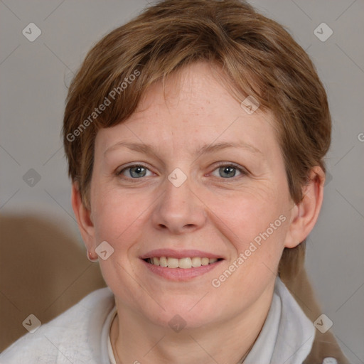 Joyful white adult female with short  brown hair and grey eyes