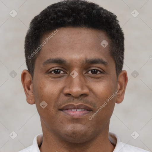 Joyful black young-adult male with short  brown hair and brown eyes