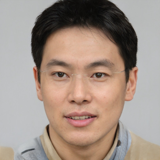 Joyful asian young-adult male with short  brown hair and brown eyes