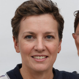 Joyful white adult female with short  brown hair and grey eyes