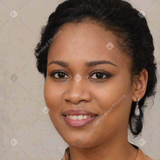 Joyful black young-adult female with long  brown hair and brown eyes