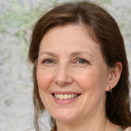 Joyful white adult female with medium  brown hair and grey eyes