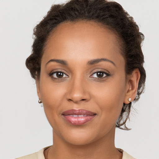 Joyful latino young-adult female with short  brown hair and brown eyes